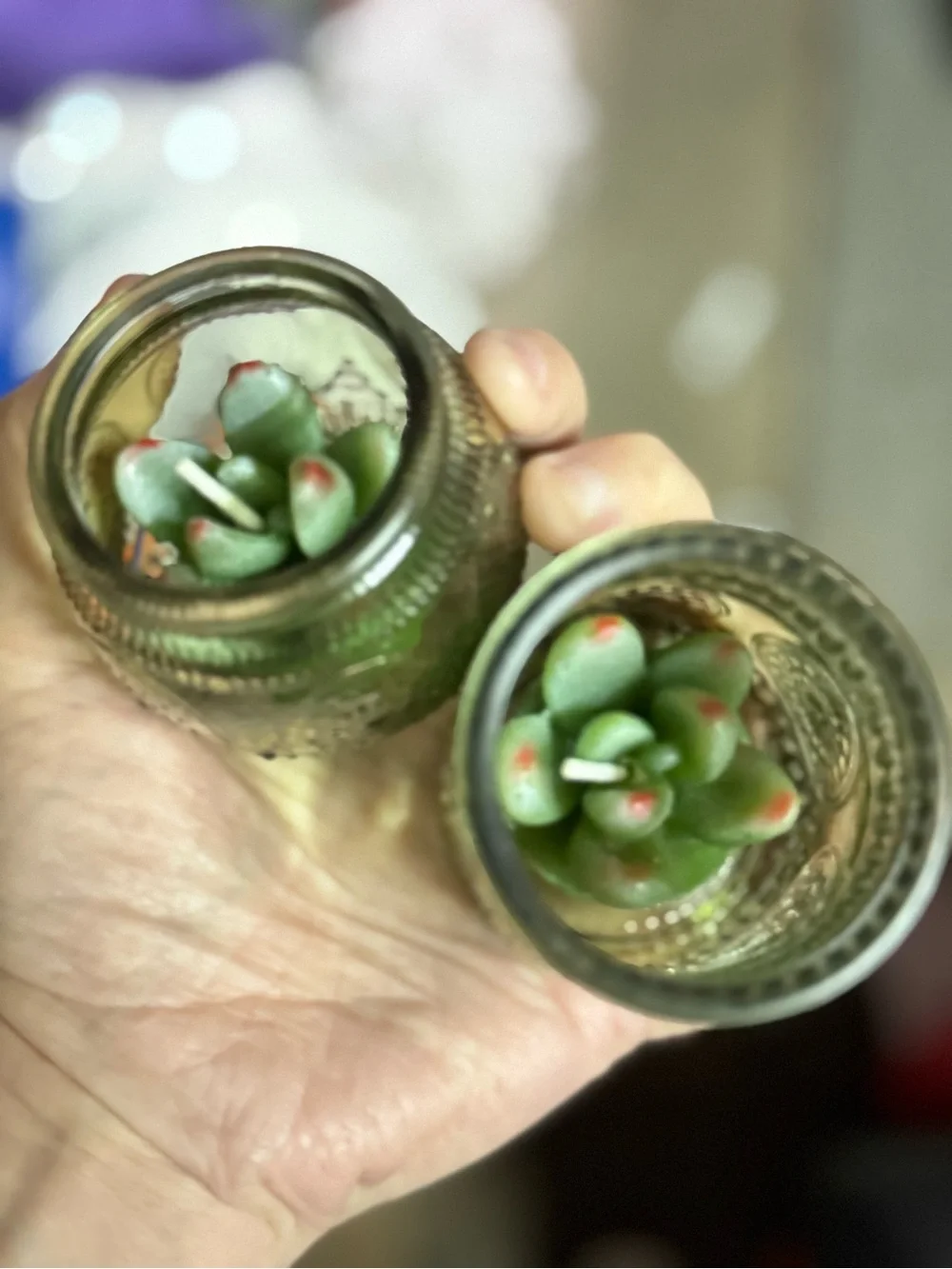 Green Glass candle holders with votive candles in them 2 different sizes